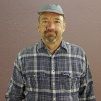 Hector Daniels Man in a gray cap with a salt and pepper mustache and goatee
